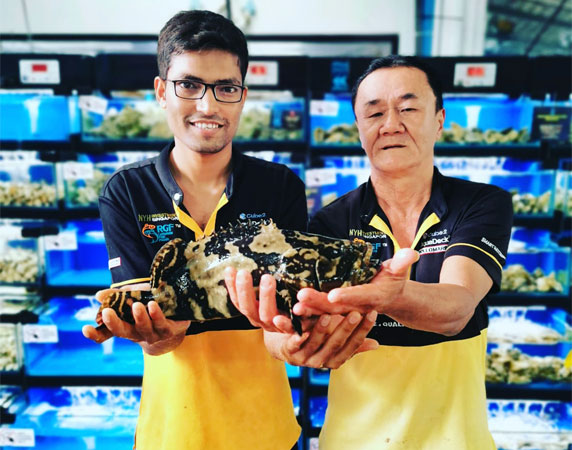 Apollo Marine Two Men Holding Big Fish